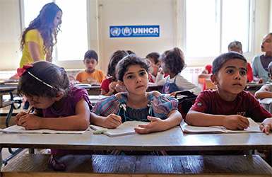 Syrian refugee children attend a make-shift school built by UNHCR. A large number of Syrian refugee children are not in school, despite efforts by governments and UN agencies